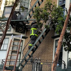 A San Francisco firefighters helped an occupant from a burning building Saturday morning. A San Francisco firefighters helped an occupant from a burning building Saturday morning.