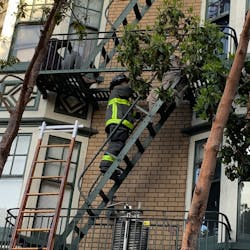 A San Francisco firefighters helped an occupant from a burning building Saturday morning.