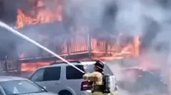 Raw video captured Manchester, NH, firefighter working swiftly to douse a raging three-alarm residential fire Sunday.