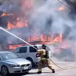 Raw video captured Manchester, NH, firefighter working swiftly to douse a raging three-alarm residential fire Sunday.