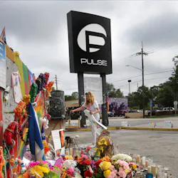 In this file photo, Pulse nightclub owner Barbara Poma tends to the memorial in front of her club on June 10, 2017, in Orlando, FL.