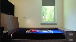 This individual sleep room includes a built-in (read: millwork) bed, a black-out shade, a task light and a built-in desk. Three vertically stacked drawers are at the foot of the bed. Storage under the standard-height mattress platform is adequate if bulky bed linens can be stored elsewhere. This individual sleep room includes a built-in (read: millwork) bed, a black-out shade, a task light and a built-in desk. Three vertically stacked drawers are at the foot of the bed. Storage under the standard-height mattress platform is adequate if bulky bed linens can be stored elsewhere.