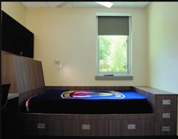 This individual sleep room includes a built-in (read: millwork) bed, a black-out shade, a task light and a built-in desk. Three vertically stacked drawers are at the foot of the bed. Storage under the standard-height mattress platform is adequate if bulky bed linens can be stored elsewhere.