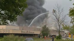 Firefighters battle a large fire that broke out at an Amherst, NY, PPE factory Tuesday. Firefighters battle a large fire that broke out at an Amherst, NY, PPE factory Tuesday.