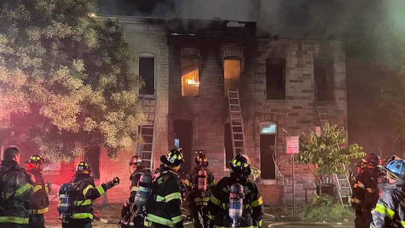 A Baltimore City firefighter underwent surgery after falling through the floor while battling a two-alarm fire late Friday.
