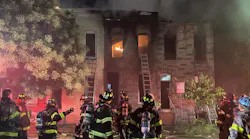 A Baltimore City firefighter underwent surgery after falling through the floor while battling a two-alarm fire late Friday.