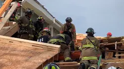D.C. Fire & EMS firefighters rescued a worker who was trapped for more than an hour beneath a collapsed building Thursday.