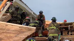 D.C. Fire & EMS firefighters rescued a worker who was trapped for more than an hour beneath a collapsed building Thursday.