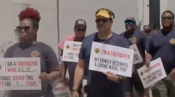 New Orleans firefighters march on City Hall on Thursday to ask to be paid a living wage for their work.