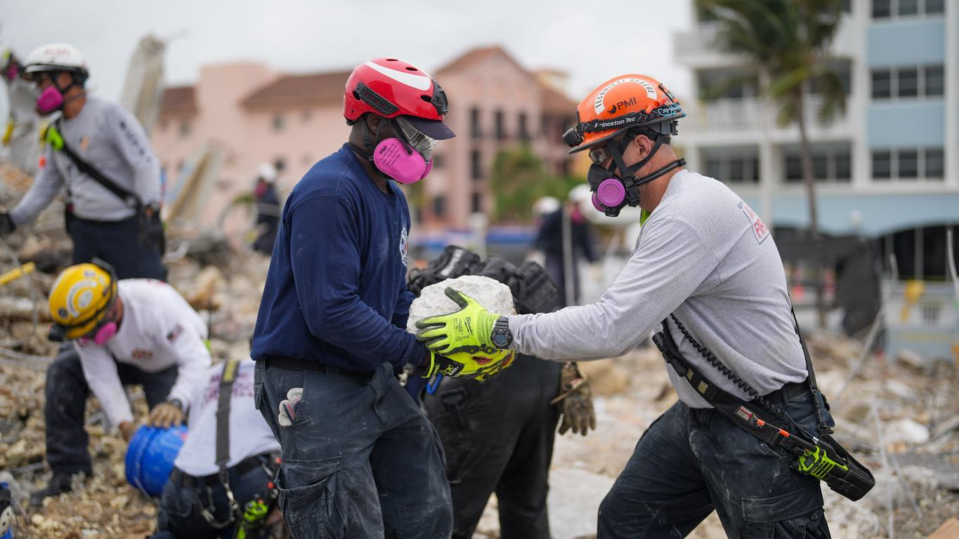 Rescue workers continue removing rocks and other debris Tuesday from the site of the Surfside, FL, condo tower collapse.