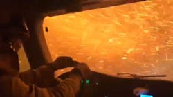 A University of California-Davis braves flames and a shower of sparks as he drives through the Tamarack Fire to protect a housing development Wednesday. A University of California-Davis braves flames and a shower of sparks as he drives through the Tamarack Fire to protect a housing development Wednesday.