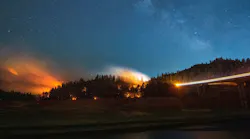 In this long exposure photograph, flames surround a drought-stricken Shasta Lake during the Salt fire in Lakehead, CA, on July 2, 2021.
