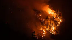 The Dixie Fire blazes off Highway 70 on July 21, 2021, in Plumas County, CA.
