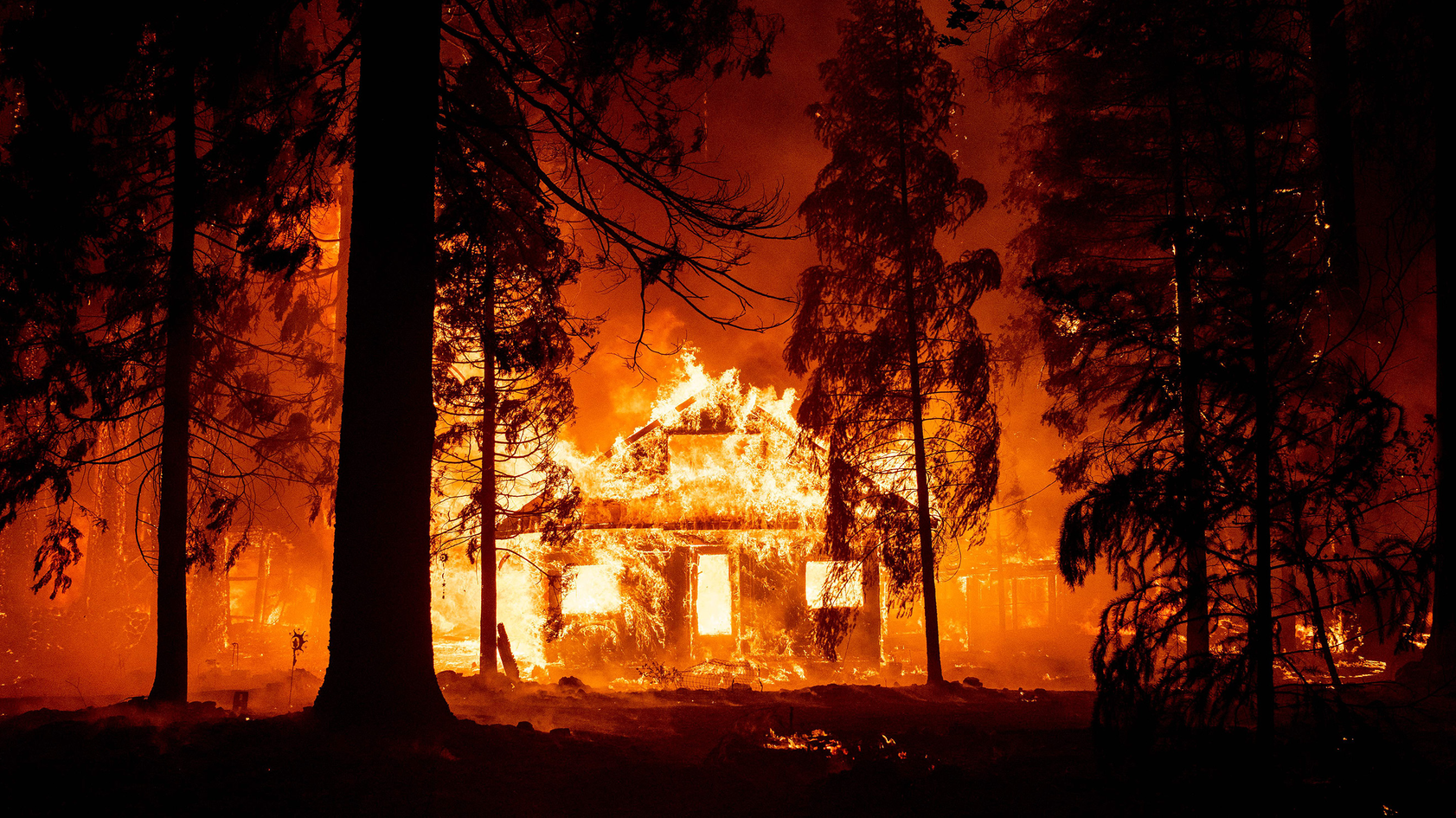 A home burns as flames from the Dixie Fire tear through the Indian Falls neighborhood of unincorporated Plumas County, CA, on July 24, 2021.