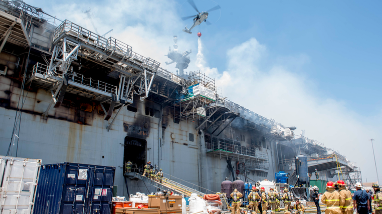 Firefighters stage their response alongside the USS Bonhomme Richard, which burned for four days in July 2020 in San Diego.