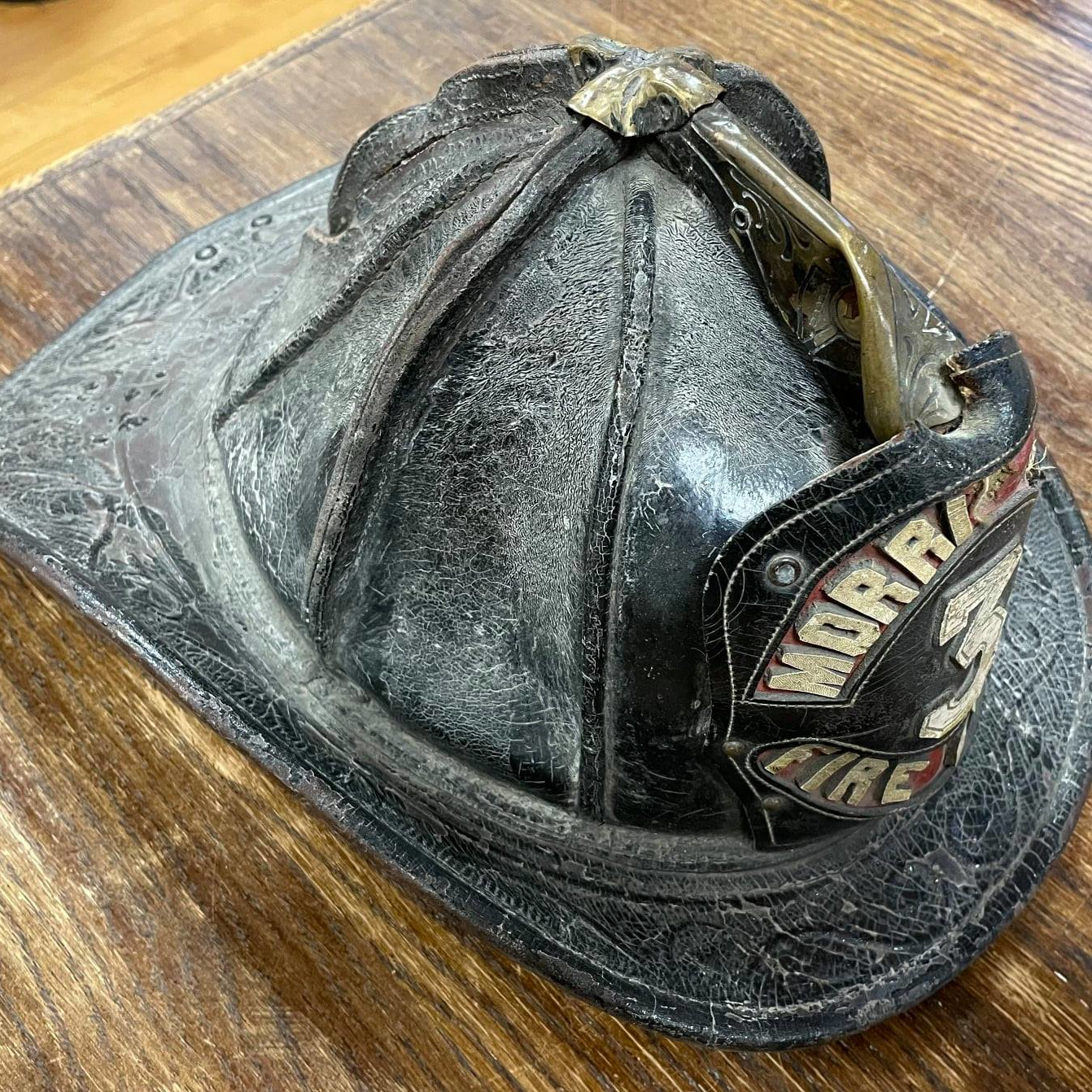 A 75-year-old Morris Plains, NJ, Fire Department helmet was recently discovered at a museum in Wasilla, AK, and it's a mystery as to how it got there and who it belonged to.