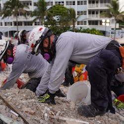 Rescue workers from task forces around the world, including Miami-Dade Fire Rescue and Israel, dig through the rubble of the collapse condo tower in Surfside, FL, on Tuesday.