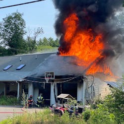 A firefighter suffered minor injuries battling a fire that was sparked by a barbecue smoker&apos;s exploding propane tank Thursday.