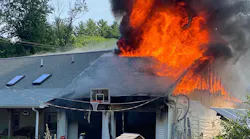 A firefighter suffered minor injuries battling a fire that was sparked by a barbecue smoker's exploding propane tank Thursday.