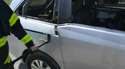 A lightweight exterior trim cover piece is removed to allow a better purchase point at the rear edge of a minivan sliding side door.