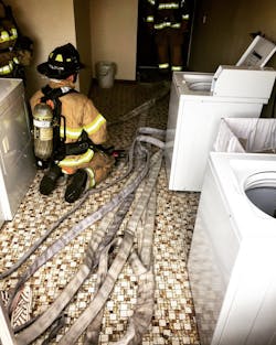 Once the hoseline has been brought into the apartment that’s adjacent to the fire apartment, the working line should be flaked out perpendicular to the hallway door to facilitate easy advancement. Once the hoseline has been brought into the apartment that’s adjacent to the fire apartment, the working line should be flaked out perpendicular to the hallway door to facilitate easy advancement.