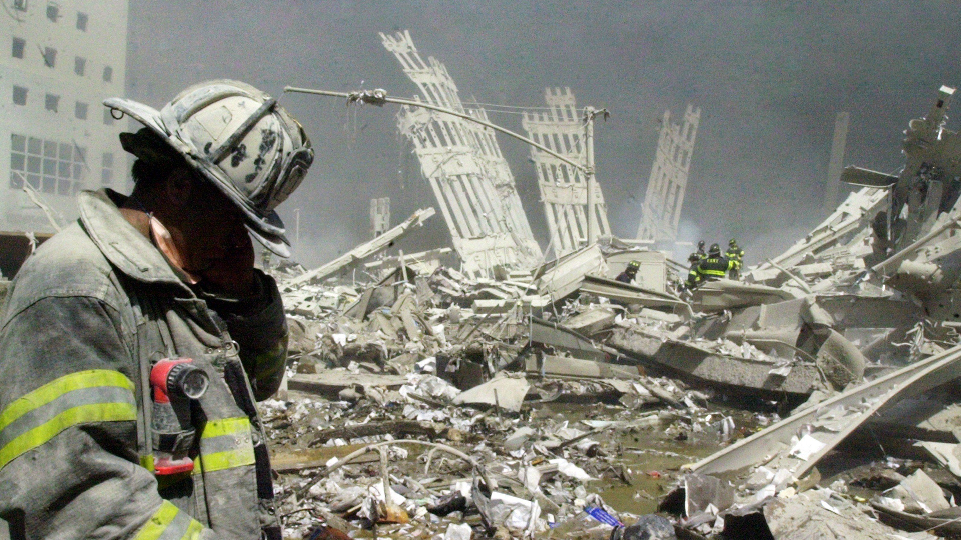 An FDNY firefighter walks through the rubble of the World Trade Center following the terror attacks of Sept. 11, 2001.