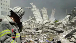 An FDNY firefighter walks through the rubble of the World Trade Center following the terror attacks of Sept. 11, 2001.