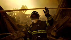 An FDNY firefighter searches through the rubble of the World Trade Center after the terror attacks of Sept. 11, 2001.