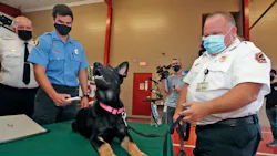 Volusia County, FL, Fire Battalion Chief Chuck Kamine, right, is pictured with his dog CoCo, which will be used to train firefighters on the use of microchip scanners.