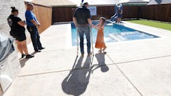 Lubbock firefighter Matt Dawson and his 7 year-old daughter look over the backyard of the new home that his family was presented with. Lubbock firefighter Matt Dawson and his 7 year-old daughter look over the backyard of the new home that his family was presented with.