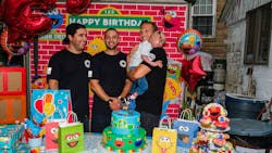 Firefighters Manuel Costa (left to right), Lawrence Young, and Steve Keenan, holding Liam Dominguez Rodriguez at Liam&apos;s third birthday party.