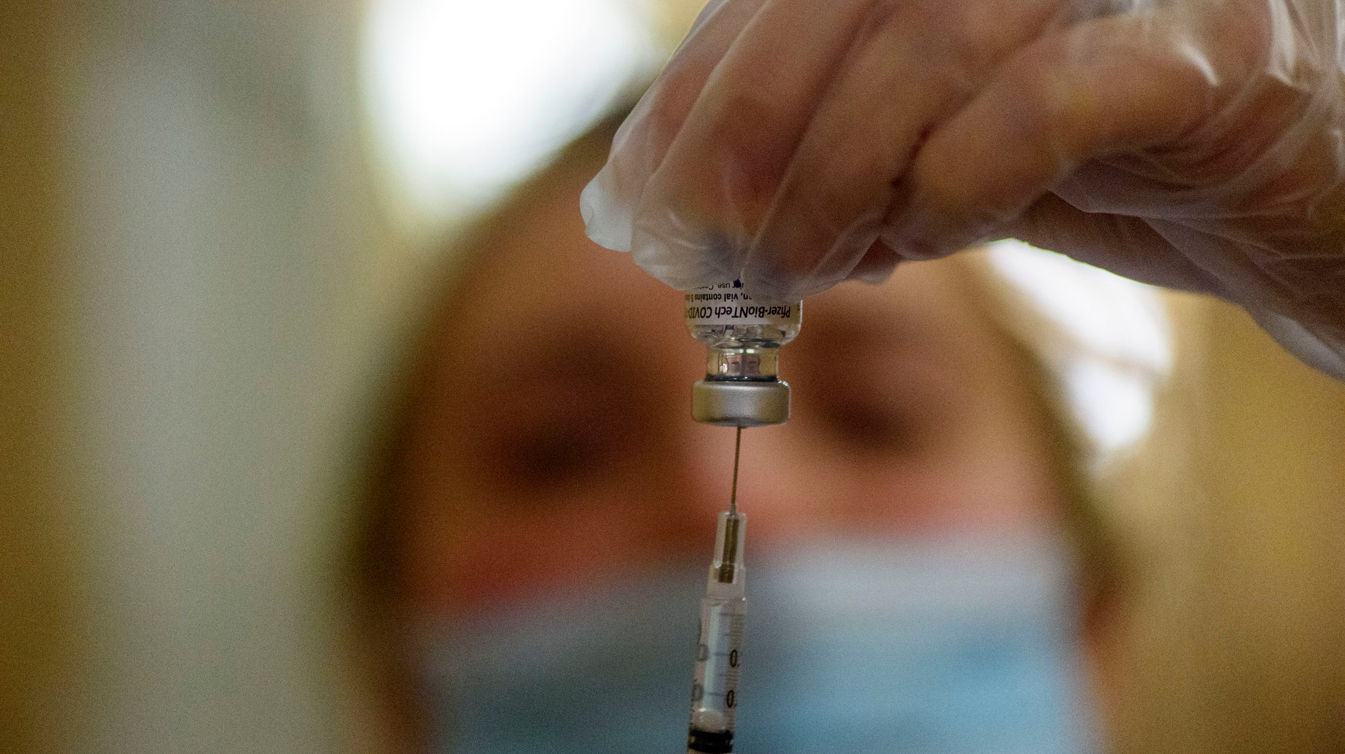 Pharmacist Tara Hubbard prepares a COVID-19 vaccination in hallway of The Retreat, a Community Renewal Team assisted-living facility in Hartford, CT, on Jan. 15.