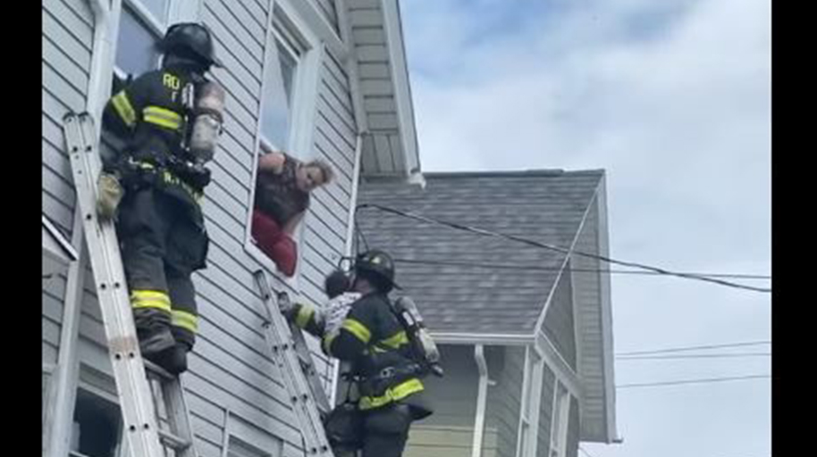 Rochester firefighters rescue a child from a house fire Thursday.