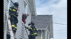 Rochester firefighters rescue a child from a house fire Thursday. Rochester firefighters rescue a child from a house fire Thursday.