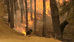 A firefighter works to contain the McFarland Fire in Shasta-Trinity National Forest in Redding, CA.
