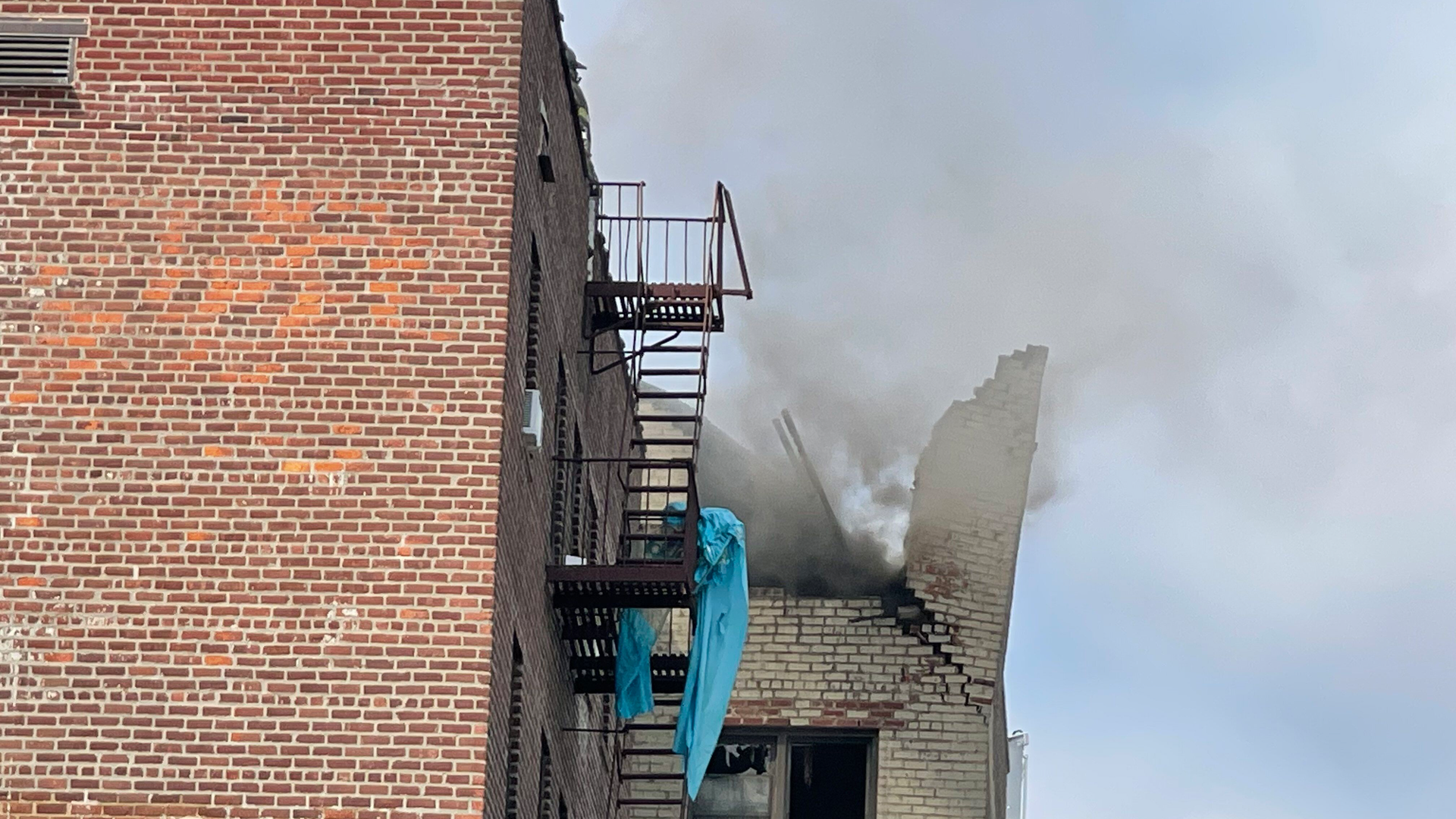 An explosion destroyed the roof of an apartment building in the Jackson Heights section of Queens on Tuesday, leaving one person dead.