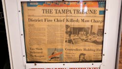 A Tampa, FL, Tribune newspaper box on display at the Tampa Firefighters Museum shows the headline reporting the fatal station fire shooting in 1981.