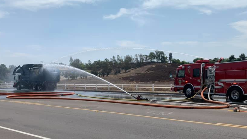 The explosion of a liquid propane tank on a burning garbage truck in Temecula, CA, severely damaged an apparatus and sent 12 firefighters to the hospital as a precaution Monday.