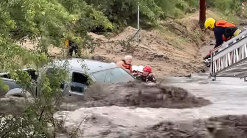 Firefighters from the Golder Ranch and Northwest fire districts rescued three people from a fast-moving, rain-swollen runoff in Tucson, AZ, on Tuesday.
