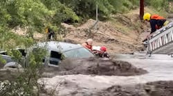 Firefighters from the Golder Ranch and Northwest fire districts rescued three people from a fast-moving, rain-swollen runoff in Tucson, AZ, on Tuesday. Firefighters from the Golder Ranch and Northwest fire districts rescued three people from a fast-moving, rain-swollen runoff in Tucson, AZ, on Tuesday.