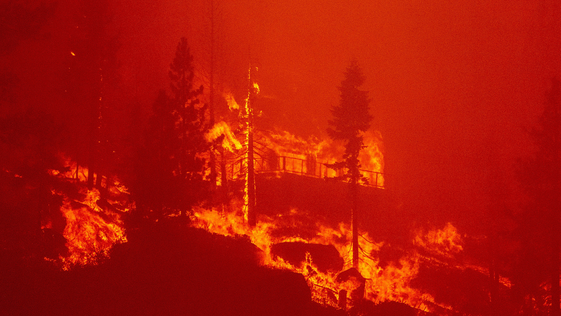 Flames consume a home as the Caldor Fire pushes into South Lake Tahoe, CA, on Monday, August 30, 2021.