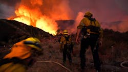 Firefighters make their way up a hill as they battle the El Dorado Fire in Yucaipa, CA, in September 2020.