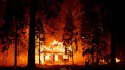 Flames from the Dixie Fire engulf a home in Indian Falls, an unincorporated area in Plumas County Saturday.
