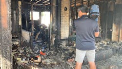 A news cameraman stands inside a home destroyed in a fire that also claimed three lives in Spokane, WA, on Sunday, Aug. 22, 2021. A news cameraman stands inside a home destroyed in a fire that also claimed three lives in Spokane, WA, on Sunday, Aug. 22, 2021.