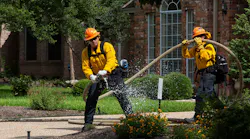 An Austin firefighter simulates a fire during a wildfire exercise in West Austin on Tuesday.