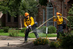 An Austin firefighter simulates a fire during a wildfire exercise in West Austin on Tuesday.