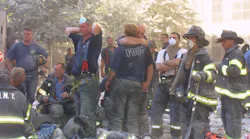 FDNY firefighters hug each other during search and rescue operations at the World Trade Center on Sept. 11, 2001.