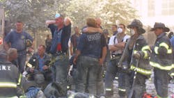 FDNY firefighters hug each other during search and rescue operations at the World Trade Center on Sept. 11, 2001. FDNY firefighters hug each other during search and rescue operations at the World Trade Center on Sept. 11, 2001.