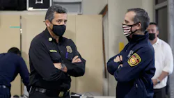 LAFD Chief Ralph Terrazas, left, and Mayor of Los Angeles Eric Garcetti talk while firefighters receive COVID-19 vaccinations at Station 4 on Dec. 28, 2020.