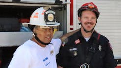 Steven Torrez, who faces the challenges of autism, is all smiles as he poses for a photo with his new friend, Firefighter Dillman of the Twin Falls Fire Department&rsquo;s technical rescue team. The fire helmet that Steven is wearing was recently donated by Cairns Helmets to Courageous Kids Climbing.